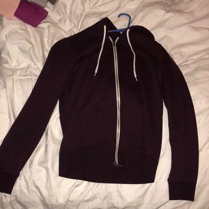 Zip up maroon sweatshirt with white strings